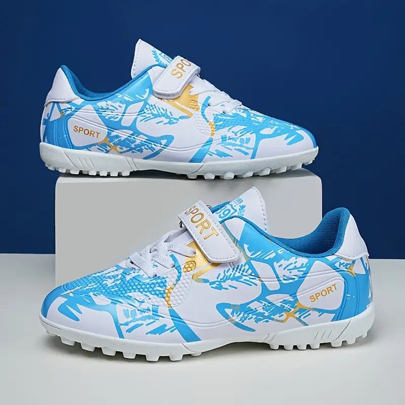 Pair of blue and white sports shoes with a graphic design on a display stand.