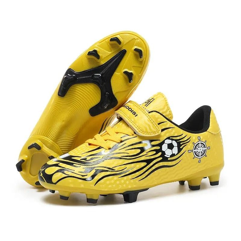 Yellow soccer cleats with black flame design and soccer ball graphic, features rubber studs for traction.